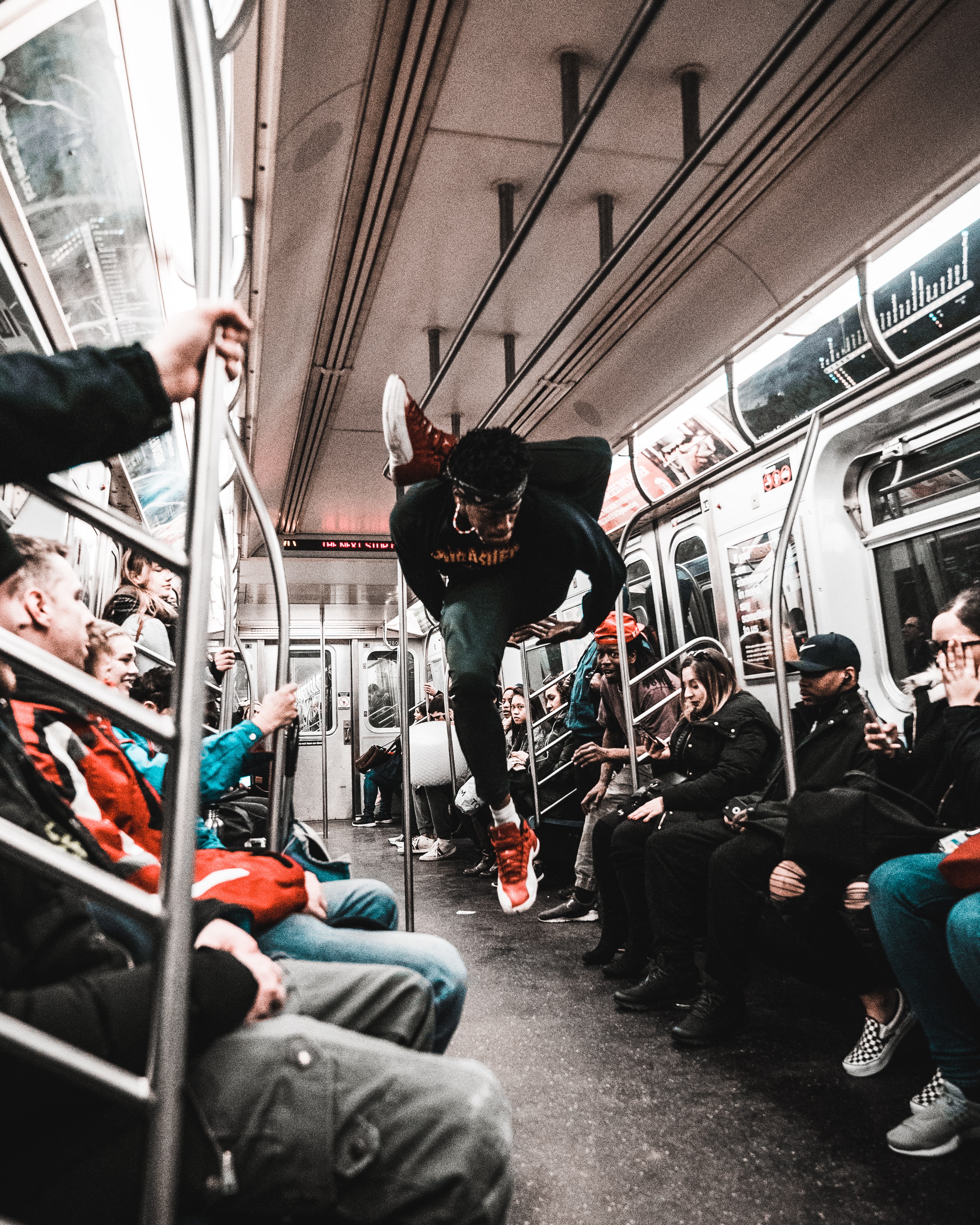 Man dancing in the aisle of a subway